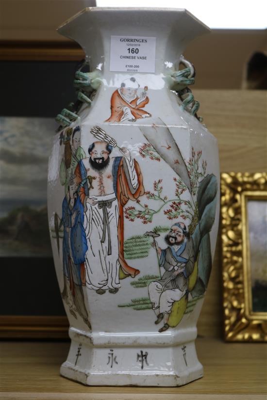 A Chinese porcelain vase decorated in enamels with figures in a garden 33cm